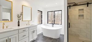 Bathroom renovation completed by renovation companies in Dubai featuring a freestanding bathtub, walk-in shower, and double vanity.
