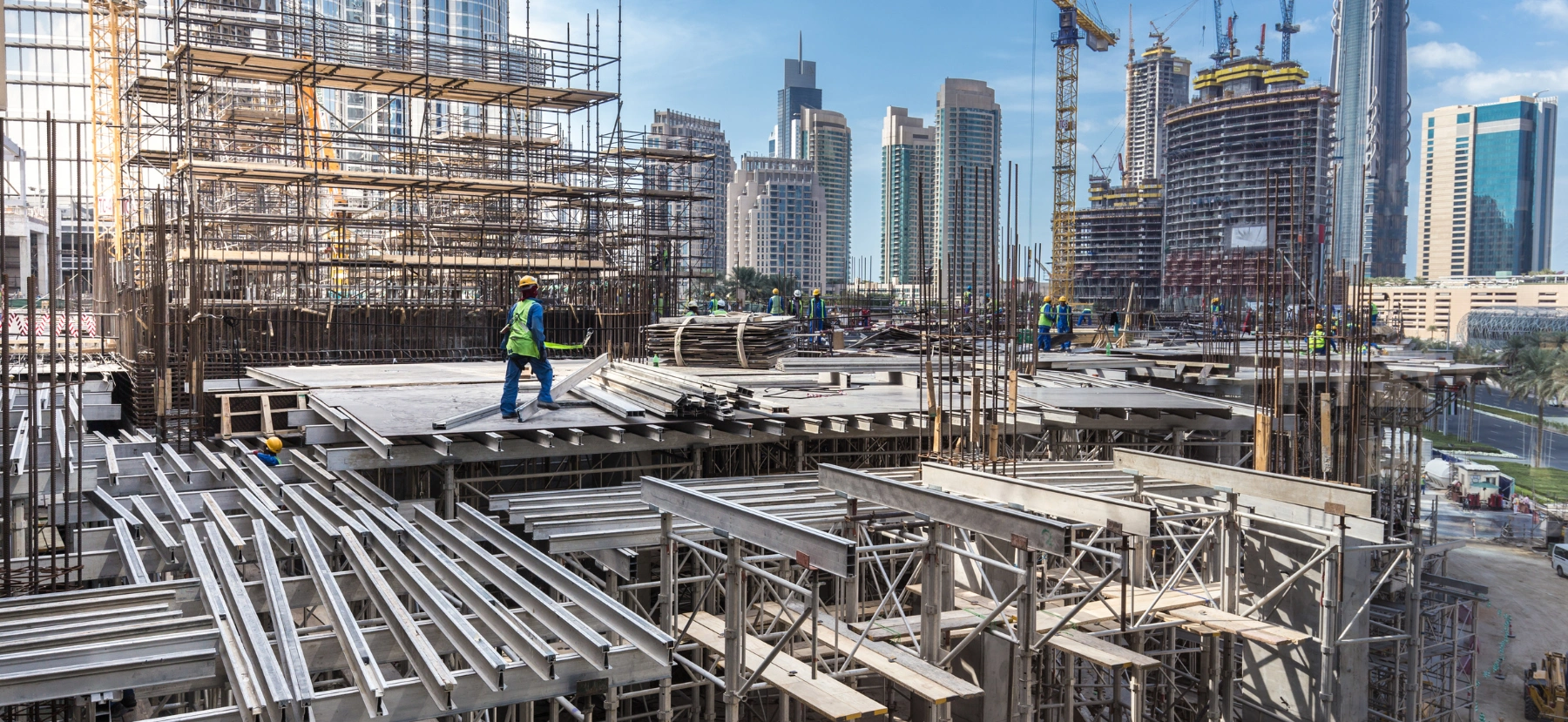 What Is Building Contracting? Active construction site in Dubai showing structural works, scaffolding, and project coordination.