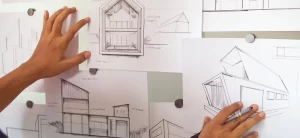 Architects reviewing building design sketches during the Design & Build planning process.